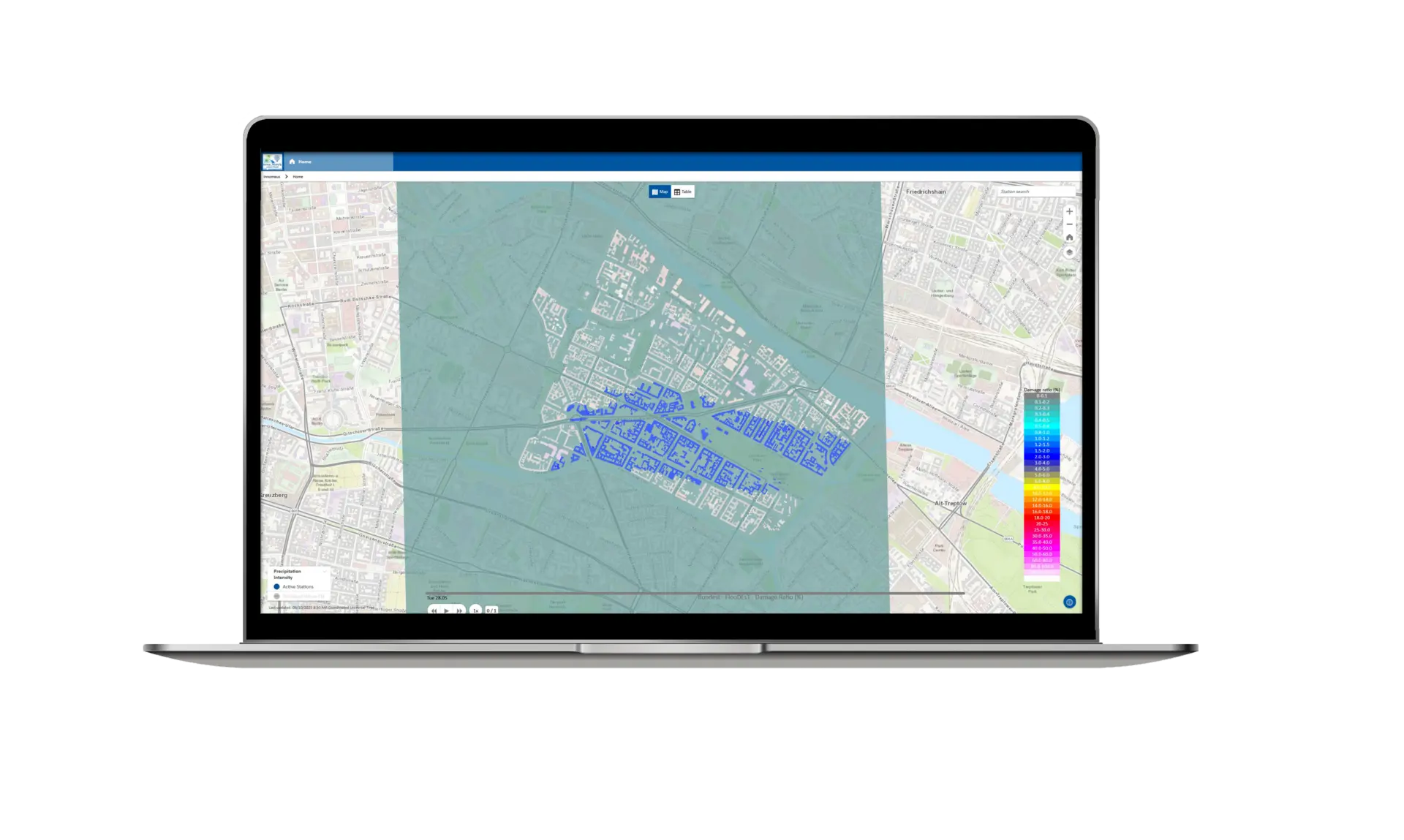 L'écran d'un ordinateur portable affiche une carte numérique avec une zone bleue ombrée au centre, entourée de rues grises et vertes. Une légende codée par couleur est visible sur le côté droit de l'écran.