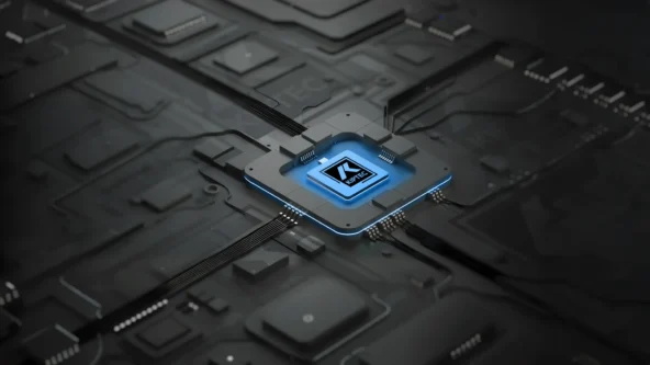 A close-up of a glowing computer chip labeled AI on a dark, futuristic circuit board, with blue accents and interconnected lines suggesting data flow and advanced technology.